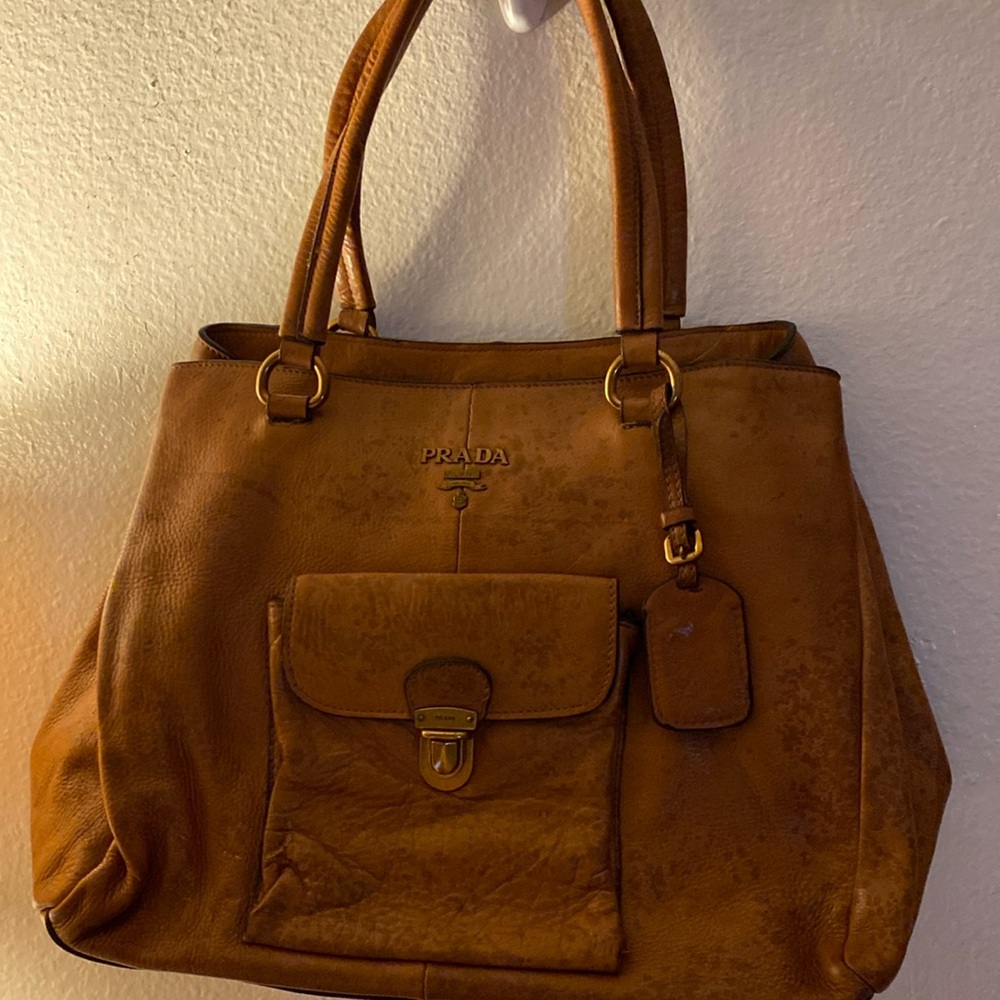 Authentic Prada handbag leather. with gold tone hardware. Good quality bag.